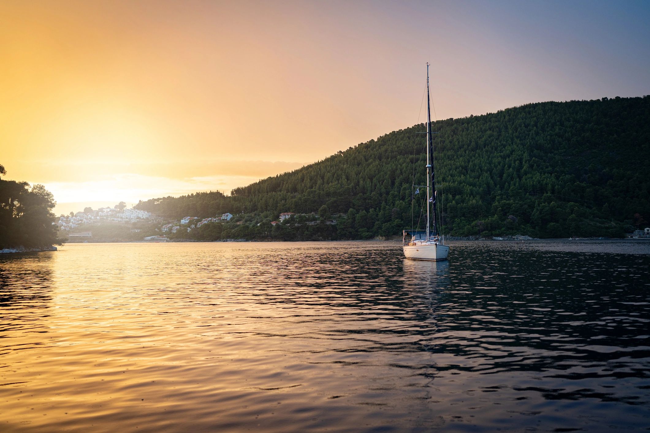 Sailboat underway in calm evening light